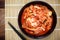 Kimchi cabbage in a bowl with chopsticks