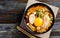 Kimchi soup with mushroom and egg yolk in a bowl