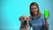 Kind animal volunteer with labrador dog showing green screen phone, charity app