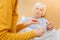 Kind attentive woman giving a pillbox to her ill grandmother