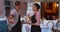 Kind black waiter and waitress welcoming viewer into nice restaurant