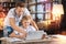 Kind father pointing to the screen while standing near his smiling son