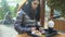 Kind female looking at poor homeless outside restaurant, treating food, donation