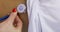 Kind female pediatrician using stethoscope to listen to breath sounds of cute little patient during medical examination