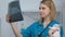 Kind female vet checking rabbit x-ray, smiling on camera, disease prevention