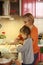 A kind grandmother teaches her granddaughter to bake cookies. The family cooks together in the kitchen. Traditions. Healthy food