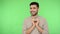 Kind hearted handsome brunette man making heart gesture and saying i love you. green background, chroma key