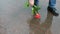 A kind man picks up a beautiful red rose from a mud puddle