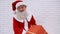 Kind mature man in Santa costume with christmas presents