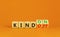 Kind on or off symbol. Businessman turns wooden cubes and changes word Kind off to Kind on. Beautiful orange table orange