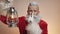 Kind smiling Santa Claus holds lamp, Christmas spirit, happy New Year tradition