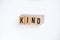 ` KIND ` text made of wooden cube on  White background
