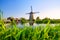 Kinderdijk National Park in the Netherlands. Windmills at the day time. A natural landscape in a historic location. Reflections on