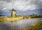 Kinderdijk windmill reflecting on the river after a storm with ominous storm clouds in the background