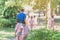 Kindergarten boy walk after female teacher and his friends back to class