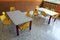 Kindergarten classroom with desks and yellow chairs