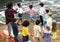 Kindergarten students standing holding hands in circle form