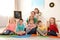 Kindergarten teacher with group of children in playroom