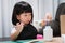 Kindergartener doing crafts shows excited expressions when she opens the glue bottle caps, child wrapped their mouths, having fun