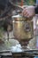 Kindling an old bronze samovar, laying firewood to heat water for brewing tea, selective focus
