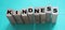 KINDNESS word made with wooden building blocks on neon aquamarine background