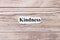 Kindness of the word on paper. concept. Words of kindness on a wooden background