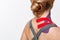 Kinesiology taping.Close up view of kinesiology tape on patient neck.Young female athlete on white background.Post