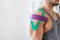 Kinesiology taping. Kinesiology tape on patient shoulder. Injure