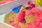 Kinetic Sand In A Heap For Indoor Game Or Children Creativity. Forms for the construction of the kinetic and pink sand scattered o