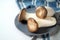 King oyster mushroom, Pleurotus eryngii, also called trumpet royale on a blue plate and kitchen towel on a white table, copy space