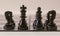 King and queen in chess with pawn army isolated on a white background. Macro photography