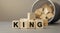 King - word concept from wooden blocks on desk