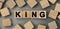 King - word concept from wooden blocks. Top view