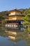 Kinkakuji golden pavilion with water reflection with clear blue sky background