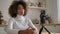 Kinky haired young blogger tells beauty tips against camera