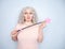 Kinky pretty woman with pink star riding crop. cute blonde woman holds bdsm whip on white solid studio background.