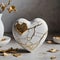 Kintsugi or kintsukuroi porcelain ceramic heart with golden cracks. Japanese art of repairing broken pottery with gold.