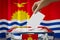 Kiribati flag, hand dropping ballot card into a box - voting, election concept