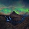 Kirkjufell in Iceland Kirkjufellsfoss waterfall and famous mountain under dancing Aurora