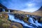 Kirkjufell mountain, Iceland. Beautiful sunset over icelandic landscape with mountain and waterfalls