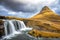 Kirkjufell mountain and Kirkjufellfoss waterfall in autumn, Snaefellsnes peninsula, Iceland. Long exposure shot