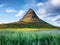 Kirkjufell. Mountains in the Iceland. High rocks and grass at the day time. Natural landscape at the summer.