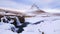 Kirkjufellsfoss waterfall and Kirkfufell mountain in winter, Iceland