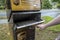 Kirkland, WA USA - circa September 2021: Angled view of a hand pulling open a UPS package and letter deposit station door in