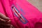Kirov, Russia - January 16, 2023: Ski jacket sleeve with zipper, logo and hand. Pink beautiful ski jacket photographed