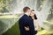 Kiss of elegant bride and groom under transparent veil