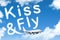 Kiss and fly an inscription in the sky left by airplanes, the concept of departure in travel