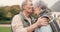 Kiss, forehead and senior couple in a park with love, happy and conversation with romantic bonding. Kissing, old people