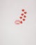 Kiss with small red hearts coming out of it on a white background. Flat lay Valentine concept. Love lipstick design idea