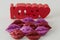 Kiss word in red with a little heart and little shinny red and purple lips